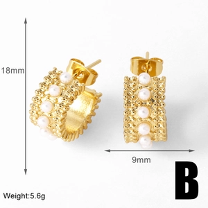 Detailed view of chunky gold teardrop earrings with embossed texture and inlaid white pearls