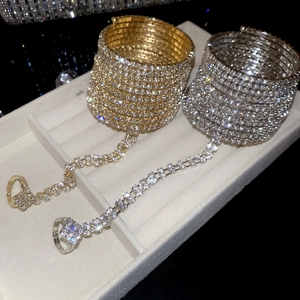 Exquisite gold and silver layered slave bracelet with shimmering rhinestone ring link