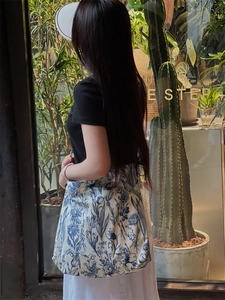 Detail of floral tie-dye cotton tote bag on model in a bohemian outdoor setting