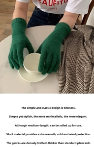 Detail of green knit wool gloves showing the dense plain stitch pattern and warm texture