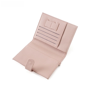 Detail of pink lychee grain leather wallet showing ID window and multiple card slots
