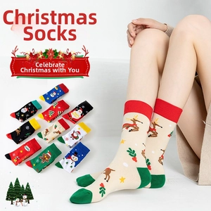 Detail view of festive cotton Christmas socks featuring Santa, reindeer and tree patterns