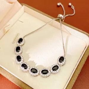 Minimalist silver-tone bracelet with oval black stones and sparkling zircon halo