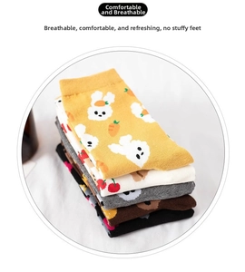 Detail of breathable cotton crew socks with cute cartoon animal patterns and pastel colors