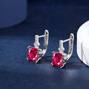 Macro shot of S925 sterling silver earrings featuring rectangular red zircon stones
