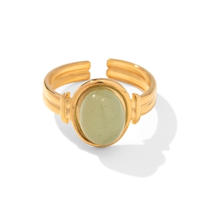 Macro view of green oval gemstone set in adjustable gold-plated stainless steel ring