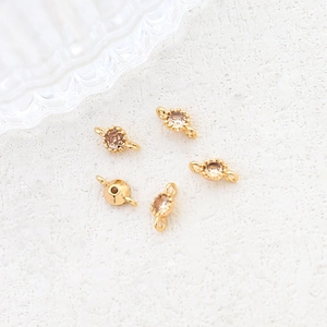 Detailed view of 5 gold plated connectors with champagne cubic zirconia for jewelry making