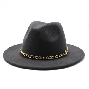 Detail of dark grey fedora hat with a decorative gold chain and wide flat brim