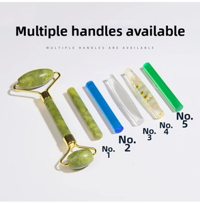 Detail of double-headed jade facial roller featuring five handle material options and gold metal frame