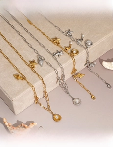 Detailed view of six ocean-themed necklaces with starfish shell and pearl charms