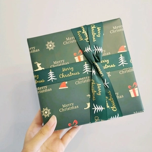 Dark green Christmas ribbon with gold Merry Christmas lettering for gift wrapping