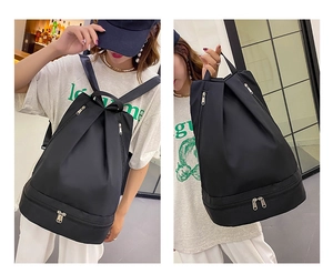 Detailed view of black Oxford backpack with separate bottom compartment for shoes and gear