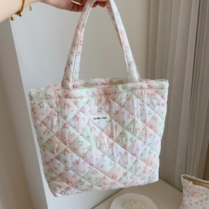 Close-up of pink floral quilted cotton handbag showing texture and simple wish fabric label