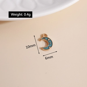 Macro shot of gold-plated moon and star charm with dimensions of 10mm x 6mm and 0.4g weight
