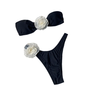 Two-piece black bikini set with white 3D floral accents on bandeau top and high-cut bottoms