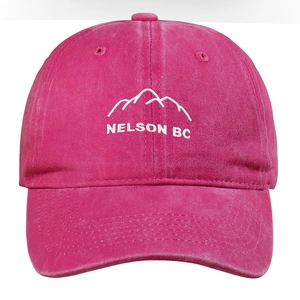 Detail of white mountain embroidery and NELSON BC text on pink washed cotton baseball cap