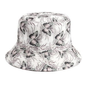 Close-up of white sun hat featuring colorful butterfly and leaf patterns on cotton fabric