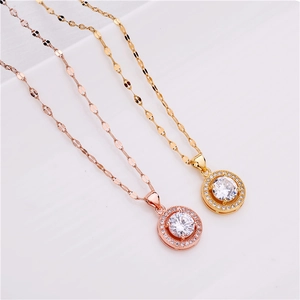 Close-up of halo round pendant necklaces in gold and rose gold with zircon inlay