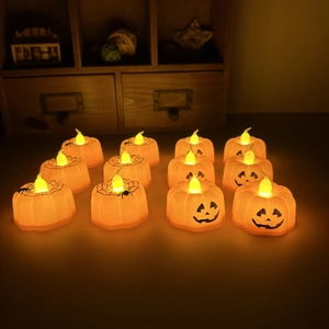 Halloween pumpkin LED tea lights with warm glow and spider web patterns for party decor