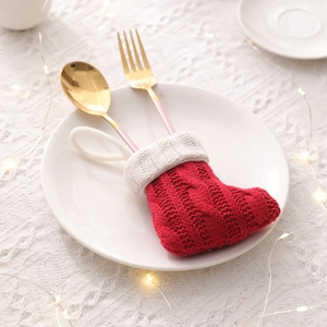 Red and white knit mini Christmas stocking cutlery holder with golden fork and spoon