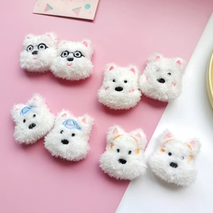 Detailed view of plush Westie dog accessories with cute embroidery and varied expressions