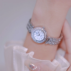 Women silver watch with mother-of-pearl dial and rhinestones on a model wrist