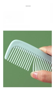 Close-up detail of a mint green plastic fine-tooth hair comb with smooth rounded tips