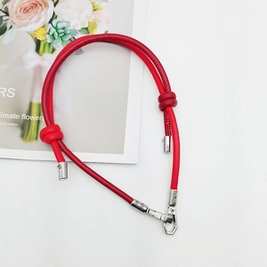 Detail of red leather woven strap with silver metal clasps for DIY bags and phones