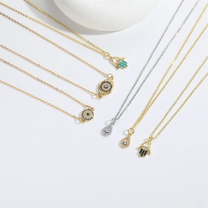 Detailed view of evil eye and hamsa hand pendants with inlaid cubic zirconia crystals