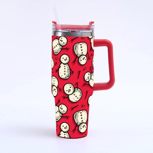 Close-up of 40oz Christmas tumbler with handle showing festive snowman pattern on red