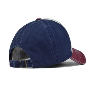 Detail view of adjustable metal buckle and tricolor patchwork vintage cotton baseball cap