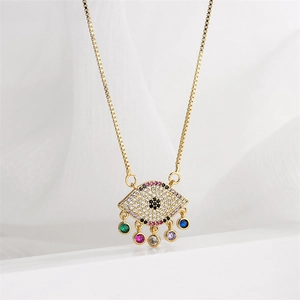 Macro shot of gold evil eye necklace pendant with vibrant colorful hanging gemstones