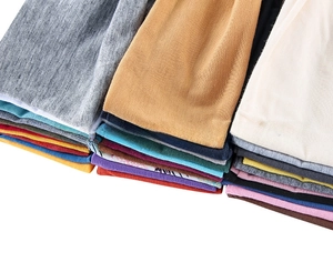 Close-up of stacked colorful elastic sports headbands in various knit fabric colors