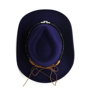 Top view of dark blue felt cowboy hat with decorative ethnic bead band and wide brim