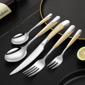 5-piece stainless steel cutlery set with golden honeycomb textured handles on black background