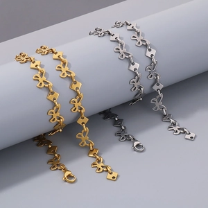 Detail of gold and silver butterfly link necklaces with stylish lobster clasp design