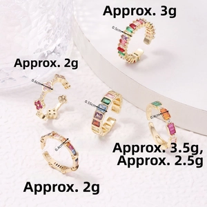 Detailed close-up of colorful clover rings with cubic zirconia on a white stand