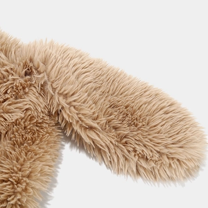 Close-up of fluffy long plush texture on cute cartoon dog ear hat in camel brown color