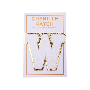 Detail of white chenille letter W patch with gold glitter edge and peel and stick backing
