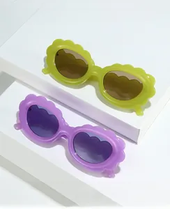Detail of cloud-shaped wavy frame sunglasses in translucent green and purple colors