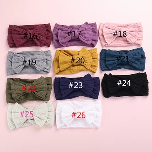 Macro detail of knit bow headbands showing various colors and cable knit textures