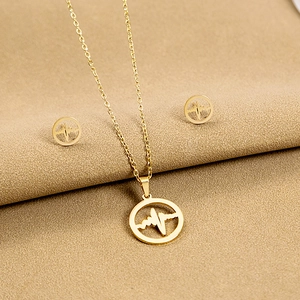 Gold stainless steel jewelry set featuring heartbeat necklace and ball stud earrings