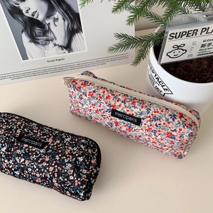 Floral corduroy pencil case and cosmetic pouch in cream and black floral patterns