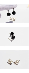 Detail of minimalist drop earrings featuring black onyx and white pearl beads on silver studs