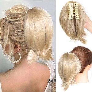 Detail view of ash blonde wavy hair bun piece with strong claw clip and textured layers