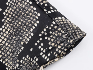 Detailed macro view of high-quality double-needle stitching on snakeskin print fabric