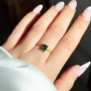 Detailed view of an 18K gold plated chain ring with emerald cut green zircon stone
