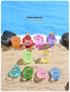 Set of 10 colorful translucent resin mini turtle figurines in beach sand scene setup