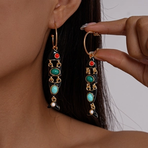 Boho fish-shaped gold drop earrings with black enamel and multi-colored gemstones