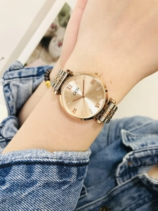 Detail of GEDI rose gold ladies watch with sunburst dial and rhinestone markers on wrist